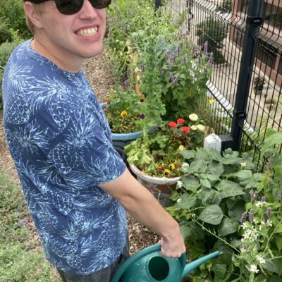 participant watering a garden